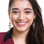 face young happy indian businesswoman smiling face young happy indian businesswoman smiling isolated against white 128979240